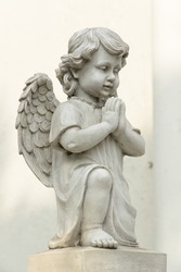 Cute winged Angel statue in praying pose
