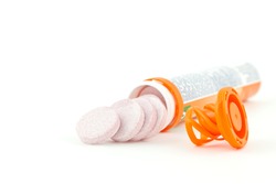Multivitamin orange tube on white background