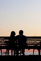 Silhouette of a young couple on a beach at sunset