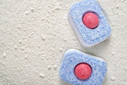 Dishwasher detergent tablets and powder. Choice concept. Copy space