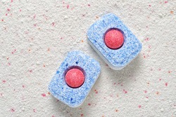 Dishwasher detergent tablets red and blue color on powder. Choice concept. Copy space