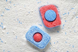 Dishwasher detergent tablets red and blue color on powder. Choice concept. Copy space