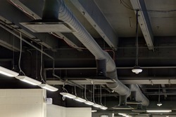 Exposed ceiling duct work in a modern high efficiency commercial HVAC system in a renovated school.