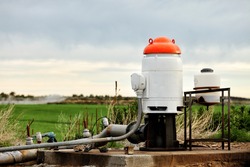 The pumping station where water is pumped from a ground well, and distributed to irrigation sprinklers in farm fields.