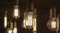 Vintage style light bulbs hanging from the ceiling. Decorative lights at home. Old Edison bulb.