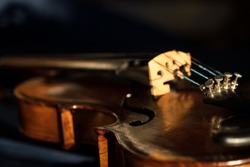 Close up of an old violin with selective focus and dark background