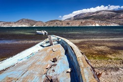 The hull of an old, damaged, boat on the seashore on the island of Kefalonia in Greece