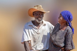 in love African American couple in their eighties and seventies, hugging and kissing, Botswana