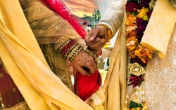 groom and bride holding hands at a hindu wedding