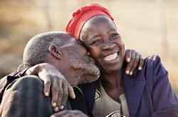 in love African American couple in their eighties and seventies, hugging and kissing, Botswana