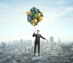 businessman flying with air balloons over the city