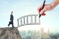 Abstract image of businessman with briefcase crossing abstract bridge drawn by hand on city background. Help concept