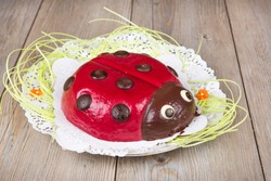 Ladybird cake on wooden background for Easter or birthday