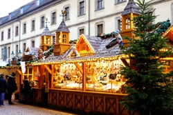 Traditional christmas market in the historic center of Nuremberg, Germany. Decorated with garland and lights sale stalls with sweets, mulled wine and Xmas decoration and German gifts.