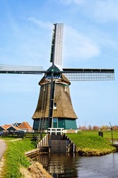 View on old windmill in Volendam, the Netherlands. Sunny day in Holland.