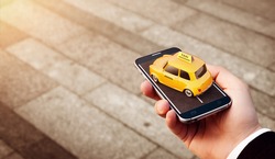 Smartphone application of taxi service for online searching calling and booking a cab. Unusual 3D illustration of taxi cab on smart phone in hand. Taxi concept