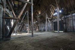 Old wooden barn with light shining through the wooden boards