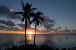 South Pacific sunset over a tropical lagoon in the Cook Islands in the South Pacific