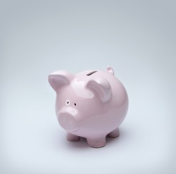 Piggy bank over gray background with copy space