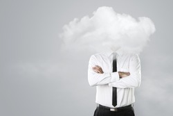 Young businessman with head in the clouds