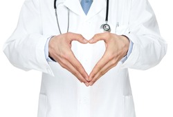 Close up of doctor's hands making heart shape isolated on white background