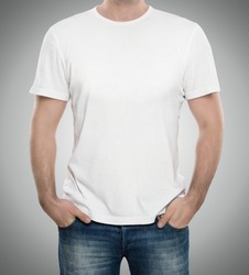Man wearing blank t-shirt isolated on gray background with copy space