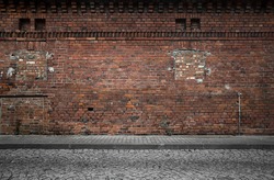 Industrial background, empty grunge urban street with warehouse brick wall