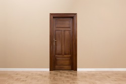 Close up of wooden door in the empty room with copy space