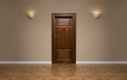 Close up of closed wooden door in the empty room with copy space