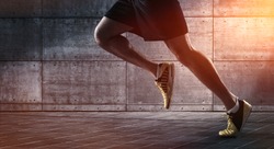 Sport background, close up of urban runner's legs run on the street with copy space