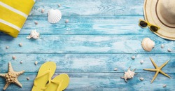 High angle view of summer, vacations, beach accessories on blue wooden background with copy space