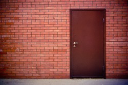 the Red brick wall and the iron closed door