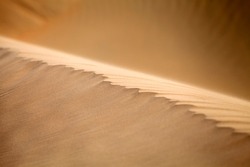Natural pattern of the sand dune in the desert in Dubai. Closeup macro texture.