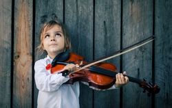 boy playing violin.Positive human facial expressions and emotions. 