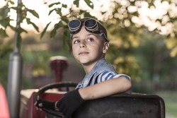 child drives a tractor, agriculture and farming
