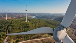 Aerial view wind turbine eco friendly renewable energy concept on Portuguese mountains background.