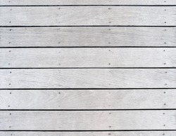 A boat dock's old weathered and faded wood decking.