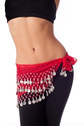 Torso of an athletic female belly dancer wearing a red colored coin belt, black sports bra and leggings. Isolated on white.