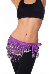 Torso of an athletic female belly dancer wearing a lavender colored coin belt, black sports bra and leggings. Isolated on white.