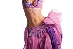 Torso of a female belly dancer wearing a pink costume and shaking her hips. Isolated on white.