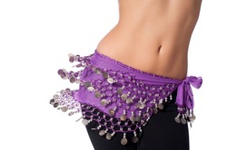 Action shot of the torso of a female belly dancer shaking her hips. She is dressed for rehearsing and practicing belly dance wearing a purple coin belt and black leggings. Isolated on white.