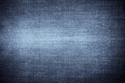 Texture of blue jeans textile close up. Blue color of denim texture with copy space for advertise or vintage background.