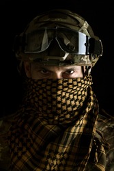 close up portrait of handsome military man. Macro shot on black background in special scarf on face