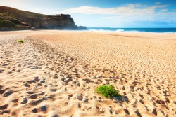 Beautiful sandy beach in Nazare, Portugal. Waves on the coast of Atlantic ocean. Famous travel destination