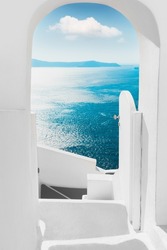 White architecture on Santorini island, Greece. Summer seascape. View of the sea and the blue sky with white cloud. Travel and summer vacations concept
