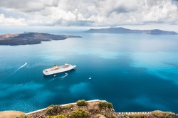 Beautiful landscape with sea view. Cruise liner at the sea near the islands. Santorini island, Greece. 
