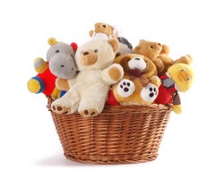 Stuffed animal toys in a basket isolated on a white background