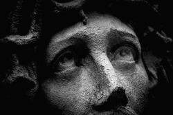 Unbearable pain in mind. Close up portrait of Jesus Christ crown of thorns. Fragment of very ancient stone statue.