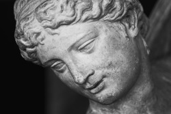 Close up face of Olympic goddess of love and beauty Aphrodite (Venus). Fragment of ancient statue. 