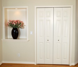 Interior photo of front closet and wall with decorated flower and light